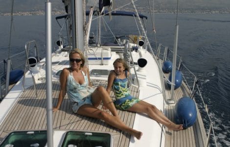 Mother and Daughter sittiong on deck of a Sailing boat